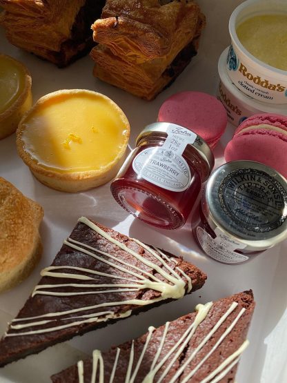 A close up of tarts, brownies and jam from the picnic box