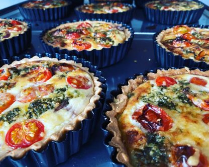 A selection of tomato and pesto quiches